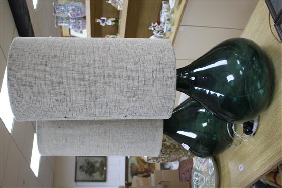 A pair of green glass lamp bases with cylindrical fabric shades, height overall 94cm, diameter 34cm